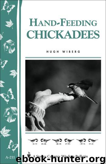 Hand-Feeding Chickadees by Hugh Wiberg